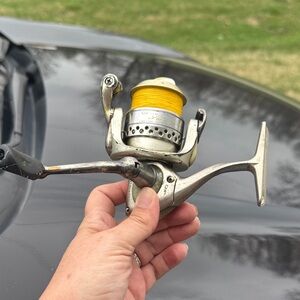 Vintage Spinning Fishing Reel with Bright Yellow Line